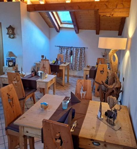 a dining room with wooden tables and chairs at Cjase Cumine in Lauco
