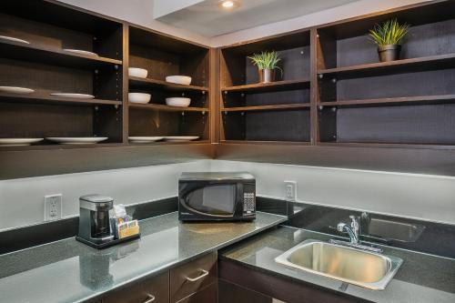 a kitchen with a sink and a microwave at Comfort Inn Belleville in Belleville