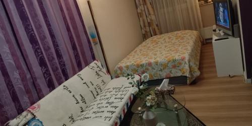 a small room with two beds and a couch at Graeff luxury Apartment in Cologne