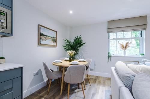 a kitchen and living room with a table and a couch at Rock Mill - The Penthouse Suite in Stony Middleton