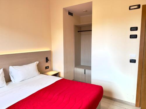 a bedroom with a bed with a red blanket at Hotel Molise 2 in Milan