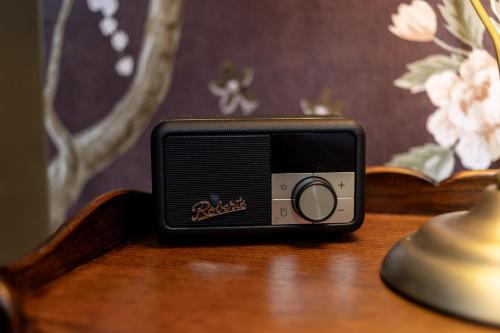a small radio sitting on top of a wooden table at The Red Lion Hotel in London