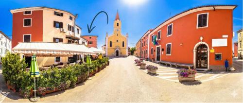 a city street with buildings and a church at Apartment Veronica - Spacious 3BR Townhouse for 6 Guests at Great Value in Brtonigla