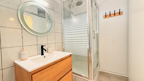 a bathroom with a sink and a shower and a mirror at Maemora - Studio in Les Trois-Îlets
