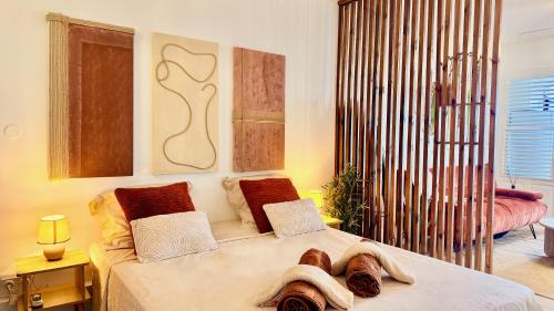a bedroom with a bed with towels on it at Maemora - Studio in Les Trois-Îlets