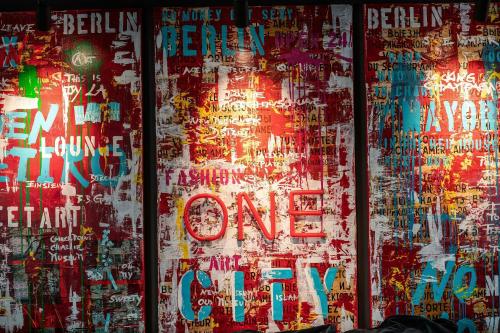 a wall covered in graffiti with the words no one on it at Motel One Berlin-Mitte in Berlin