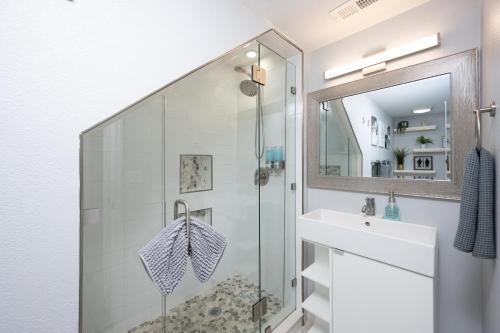 a bathroom with a shower and a sink at Huge Loft Style 3BR - KING Bed, Pool, WiFi, Washer & Dryer, AC, Free Parking -- IDEAL FOR Medical, Business, Groups, Relocation - near Moffitt Cancer Center and Raymond James Stadium -- Centrally Located in Tampa