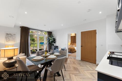 a dining room and living room with a table and chairs at Rock Mill - Deluxe 1-Bedroom Apartments in Stony Middleton