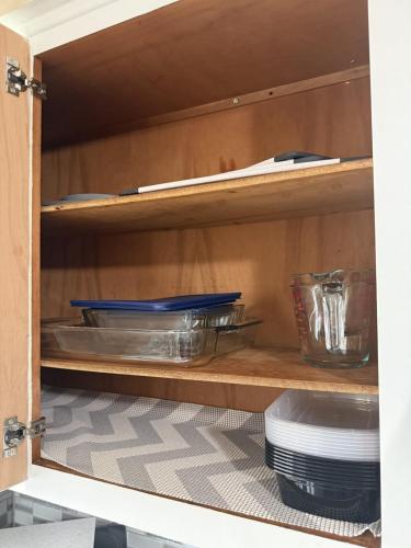 a cupboard with plates and bowls and other dishes at Akron 2 Bed 1 Bath Mountain Oasis Dog Friendly in Akron