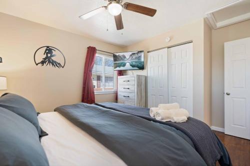 a bedroom with a bed and a ceiling fan at Akron 2 Bed 1 Bath Mountain Oasis Dog Friendly in Akron
