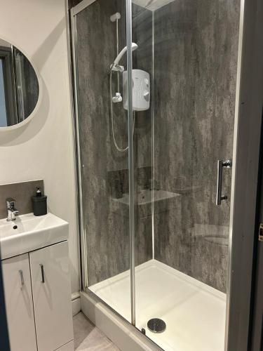 a shower stall in a bathroom with a sink at Studio 3 - Eign St Hereford in Hereford