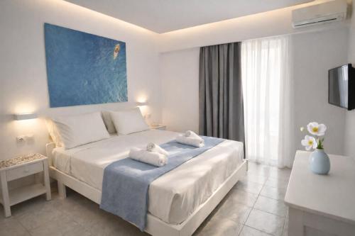 a hotel room with a bed with towels on it at Casa al' Tati Apartments in Ialysos