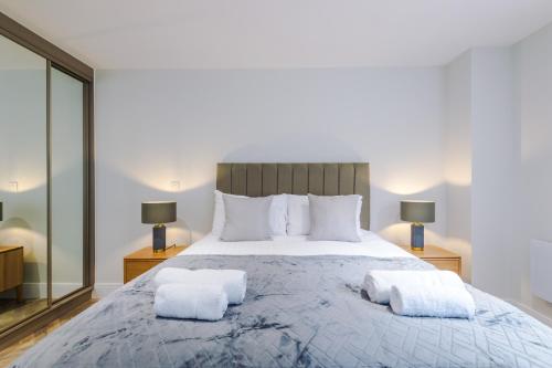 a bedroom with a large bed with two towels on it at Rock Mill - Stunning Studio Apartment in Stony Middleton
