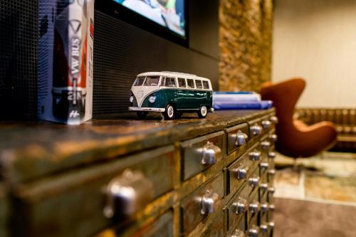 a toy bus is sitting on top of a dresser at Motel One Frankfurt-East Side in Frankfurt