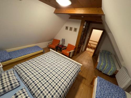 an attic room with two beds and a desk at Chalúpka pod Rozsutcom in Zázrivá
