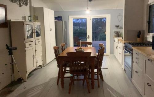 a kitchen with a table and chairs in a room at Cobargo ButterHaus in Cobargo