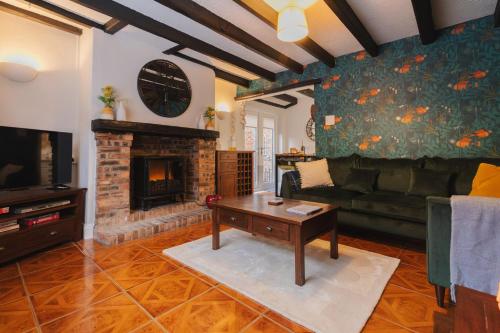 a living room with a couch and a fireplace at Silver Cottage on Yarm High street and the River free parking available in Yarm