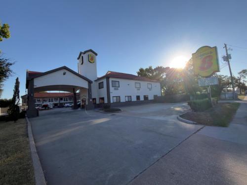 an empty parking lot in front of a gas station at Super 8 by Wyndham Houston/Brookhollow NW in Houston