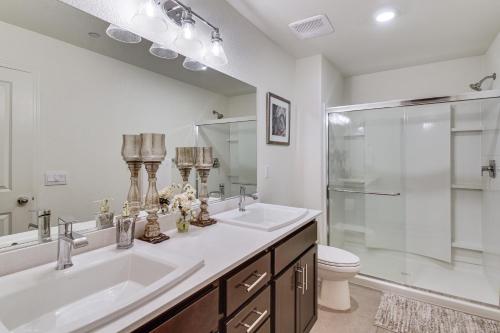 a bathroom with a sink and a shower and a toilet at Pool Table & Patio! Spacious Merced Getaway in Merced
