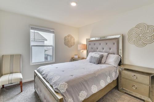 a bedroom with a bed and a chair and a window at Pool Table & Patio! Spacious Merced Getaway in Merced