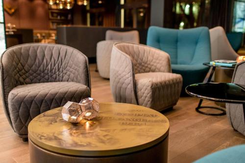 a ring sitting on a table in a room with chairs at Motel One München-Olympia Gate in Munich