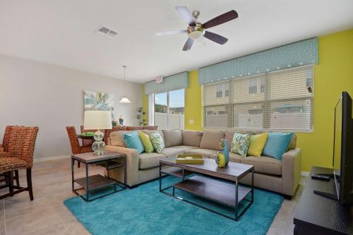 a living room with a couch and a ceiling fan at Four Bedrooms Townhouse 5102 in Kissimmee