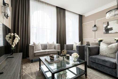 a living room with a couch and a table at Luxury Georgian City Retreat by Sovo Apartments in Edinburgh