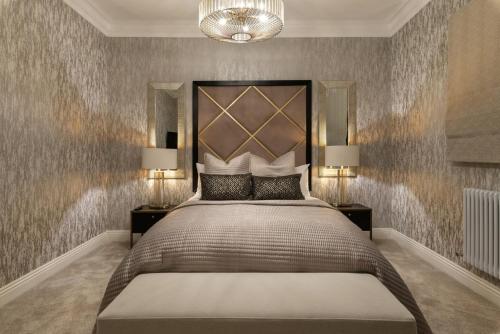 a bedroom with a large bed with two night stands at Luxury Georgian City Retreat by Sovo Apartments in Edinburgh