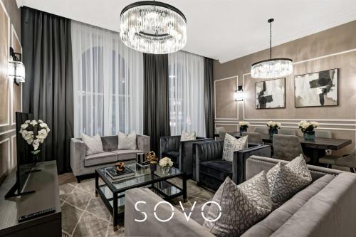 a living room with a couch and a table at Luxury Georgian City Retreat by Sovo Apartments in Edinburgh