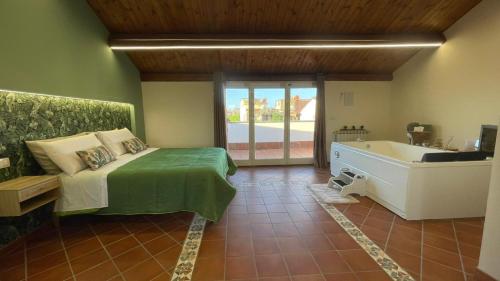 a bedroom with a bed and a tub in a room at Oasi Perla Del Mare Rooms in Aci Castello