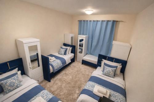 a room with three beds and two mirrors at ALEX Hostel - Bed in a shared room - H101 in Sharjah