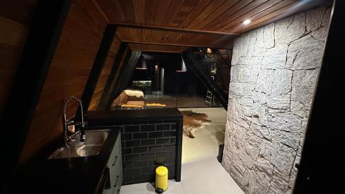 a bathroom with a sink and a mirror at Black Hut in Domingos Martins