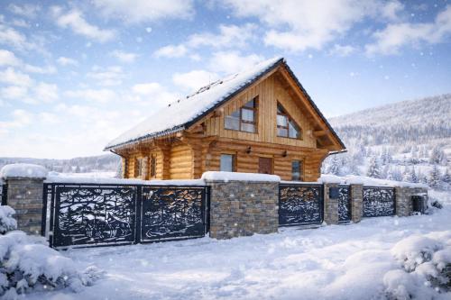 a log cabin in the snow with snow at Zrub Šumiac in Šumiac