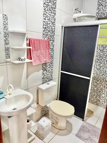 a bathroom with a toilet and a sink and a shower at Sítio Harmonia! in Harmonia