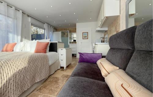 a bedroom with a large bed and a couch at Studio Tout Confort in Fondettes