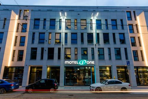 a building with cars parked in front of it at Motel One Stuttgart-Bad Cannstatt in Stuttgart
