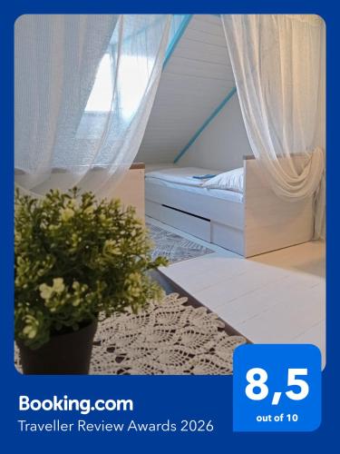 a bedroom with a bed and a potted plant at Guesthouse "Malena" in Karlovy Vary