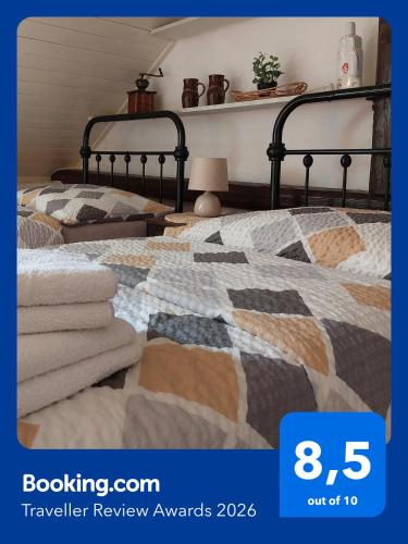 a poster of a bedroom with two beds at Guesthouse "Malena" in Karlovy Vary