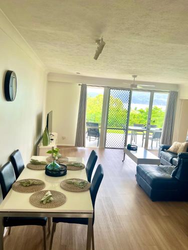 a living room with a table and a couch at Hamilton Island Poinciana 008 Ground Floor 2bedrooms Free Buggy in Hamilton Island