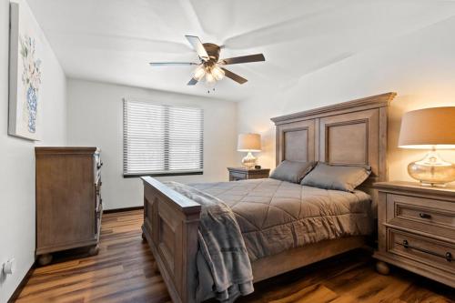 a bedroom with a bed and a ceiling fan at Three Bedroom Ranch walking distance to Lambeau in Green Bay