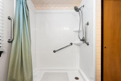 a bathroom with a shower with a shower curtain at Three Bedroom Ranch walking distance to Lambeau in Green Bay