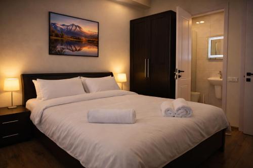 a bedroom with a bed with two towels on it at Chill House in Kutaisi