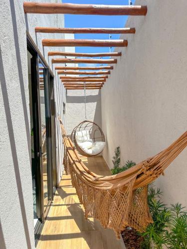 a hammock on the balcony of a house at Casa Don Magalhães in Barra de São Miguel