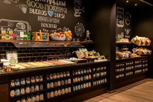 a bakery with a lot of food on display at Motel One Stuttgart-Feuerbach in Stuttgart