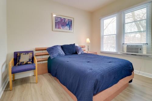a bedroom with a blue bed and a blue chair at Modern Updates & Great Location! Detroit Duplex in Detroit
