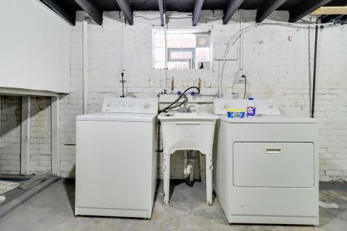 a kitchen with two washers and a sink in a room at Modern Updates & Great Location! Detroit Duplex in Detroit
