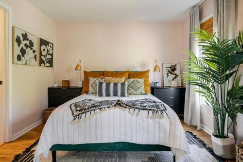 a bedroom with a bed and a potted plant at Lush, Spacious Intown Retreat in Atlanta