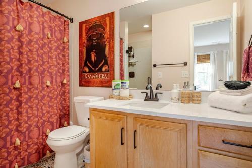 a bathroom with a toilet and a sink and a shower at Lush, Spacious Intown Retreat in Atlanta