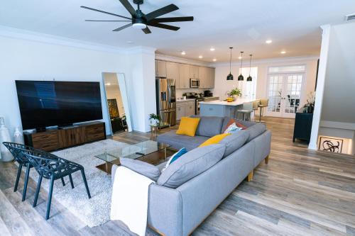 a living room with a couch and a tv at Ensuite King bedroom in Charlotte