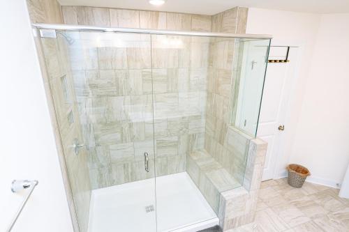 a shower with a glass door in a bathroom at Ensuite King bedroom in Charlotte